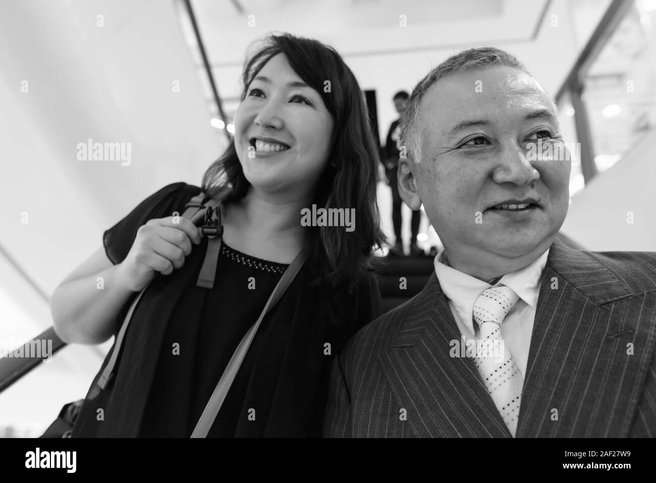 Mature Asian businessman and mature Asian woman exploring the city together Stock Photo