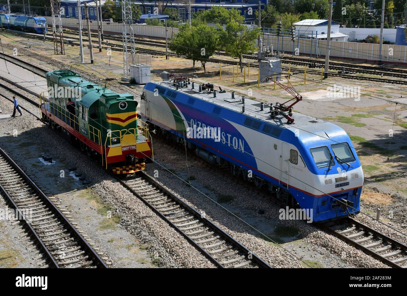 Diesel locomotive CME3T-7396 and electric locomotive OZ-Y0113 on 11.09.2019 in the station Tashkent - Uzbekistan. | usage worldwide Stock Photo
