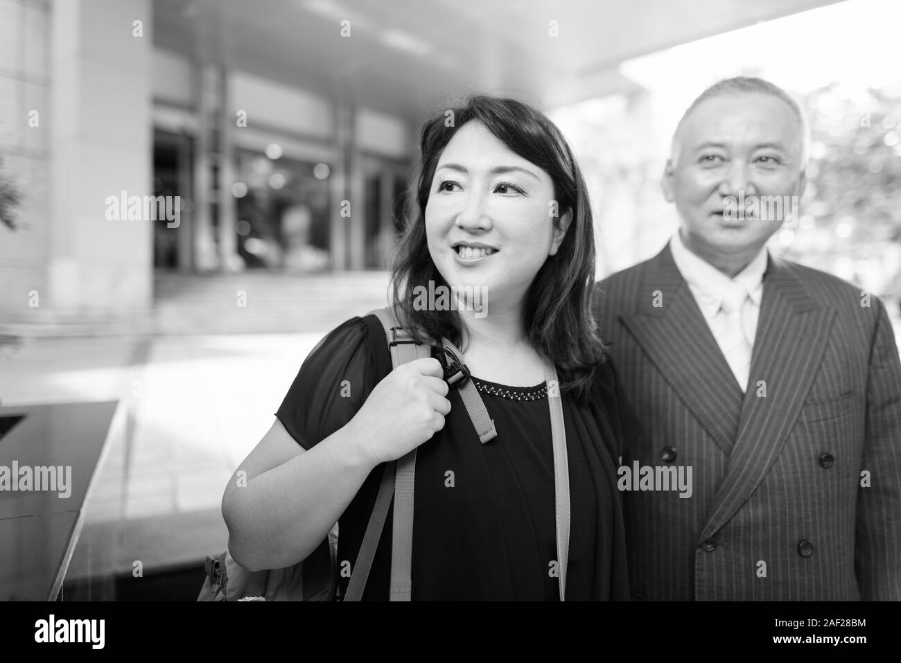 Mature Asian Businessman And Mature Asian Woman Exploring The City