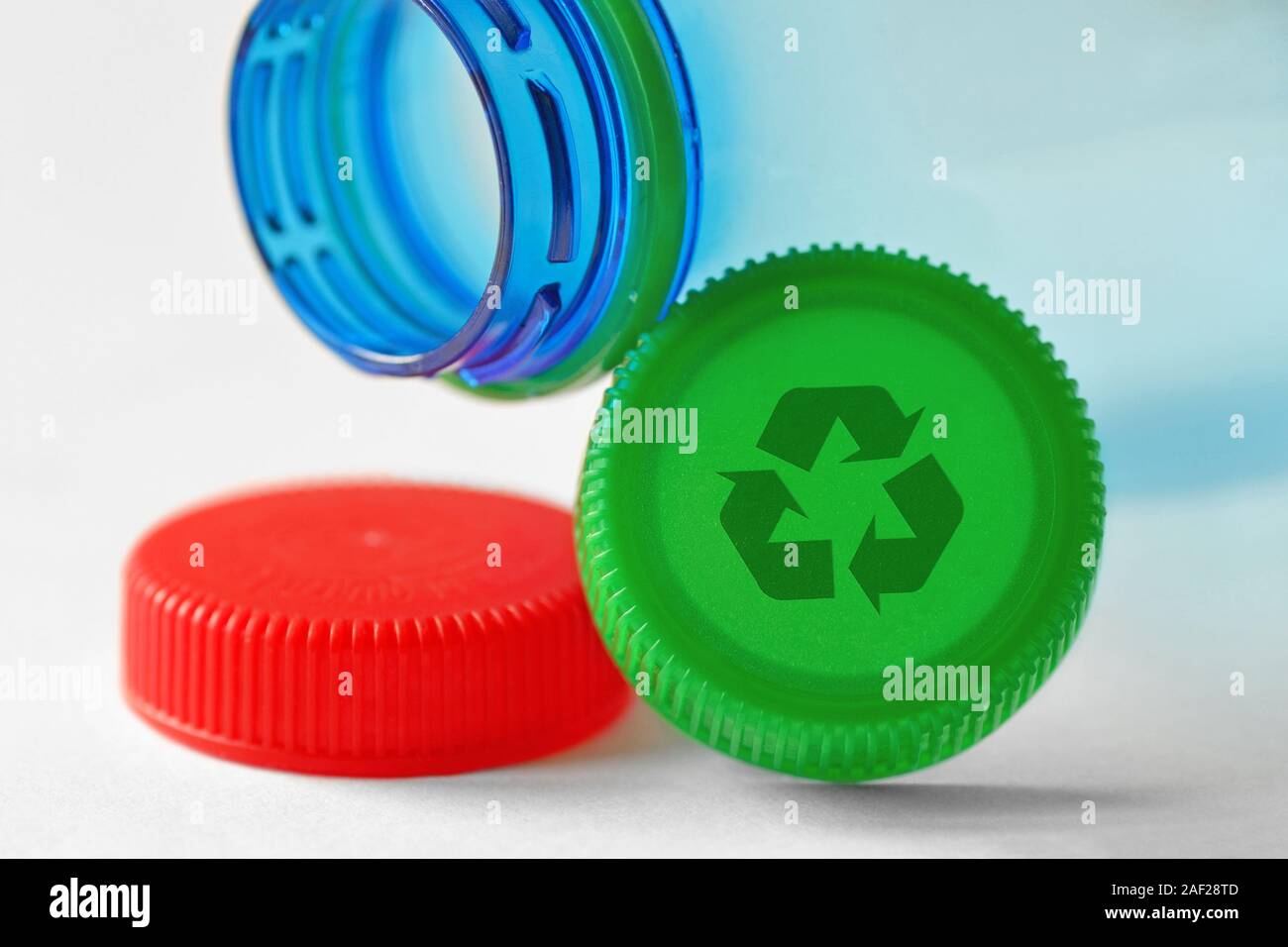 Plastic bottle and caps with recycle symbol on white background Concept of recyclable items