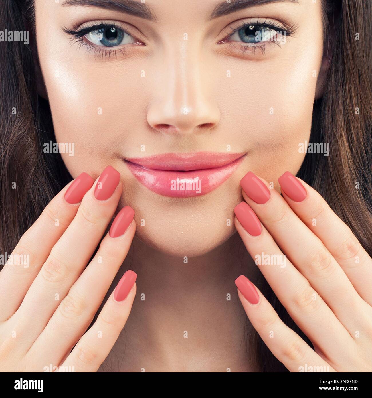 Female hand with manicured nails. Pink lips makeup and pink nailpolish, beauty manicure concept Stock Photo