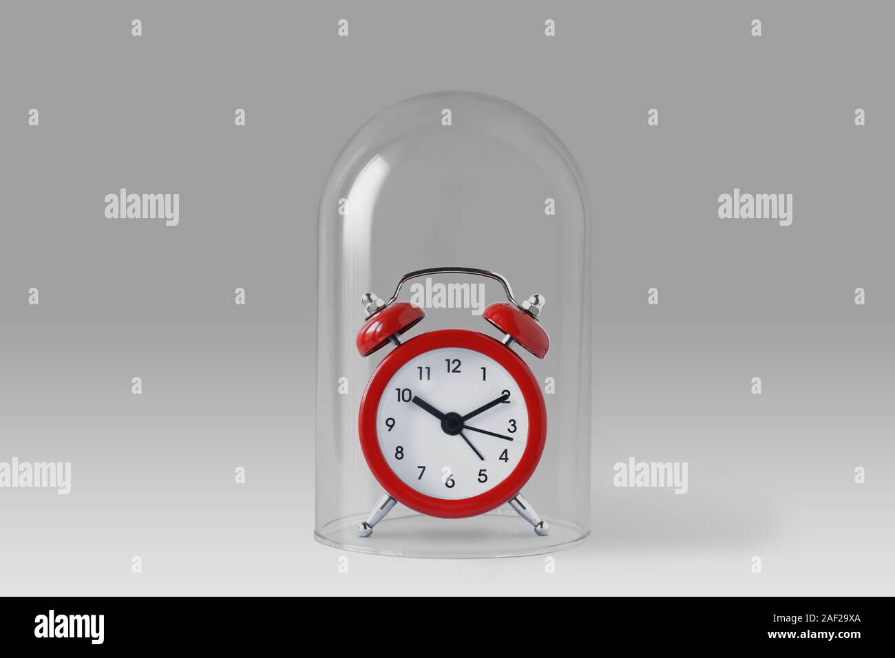 Alarm clock under glass bell Concept of saving time Stock Photo Alamy