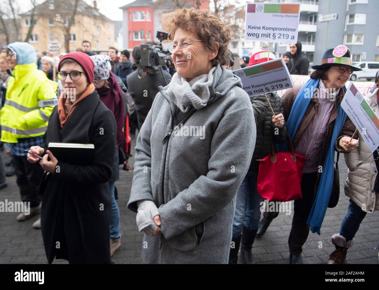 12 December 2019, Hessen, Gießen: The gynaecologist Kristina Hänel stands before the court between her supporters. The regional court concerns itself again with the question whether the lady doctor offended against the controversial abortion paragraph 219a. The public prosecutor's office accuses Hänel of having offered abortions as a service on its website and thus violated the law. Photo: Boris Roessler/dpa Stock Photo