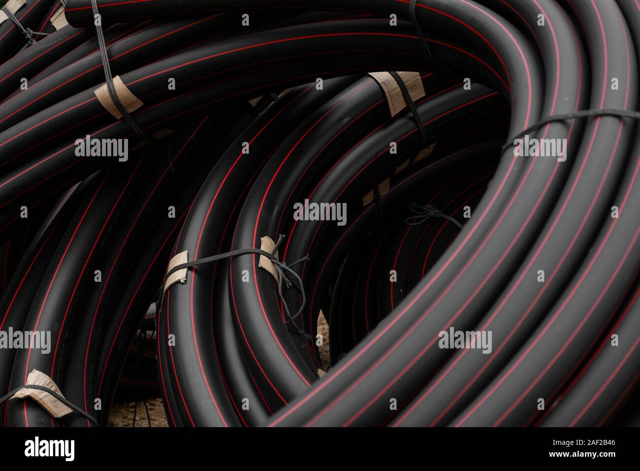 Pipe Red Line Black rubber or plastic pipes with a red lines as a construction ...