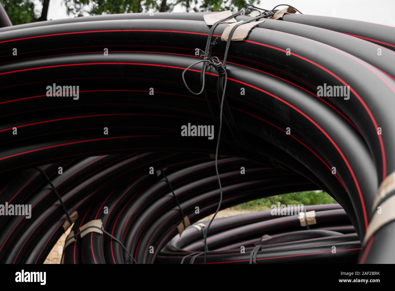 Pipe Red Line Black rubber or plastic pipes with a red lines as a construction ...