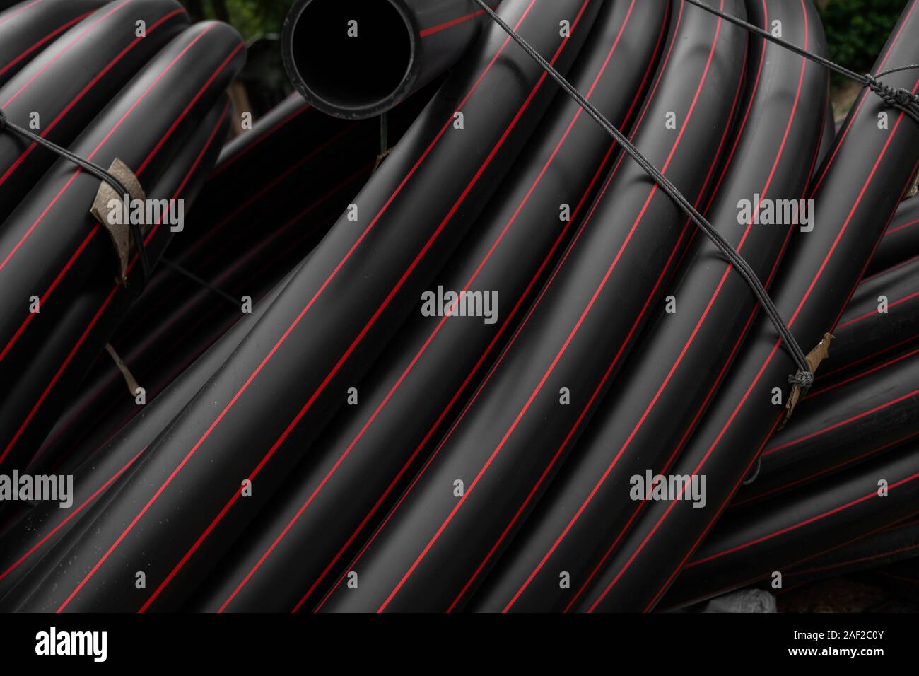 Pipe Red Line Black rubber or plastic pipes with a red lines as a construction ...