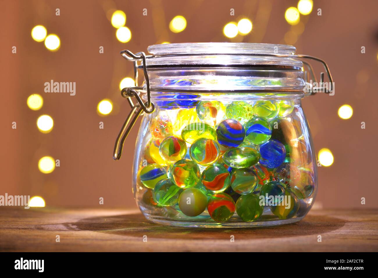 Jar of Marbles and Christmas festive lights Stock Photo