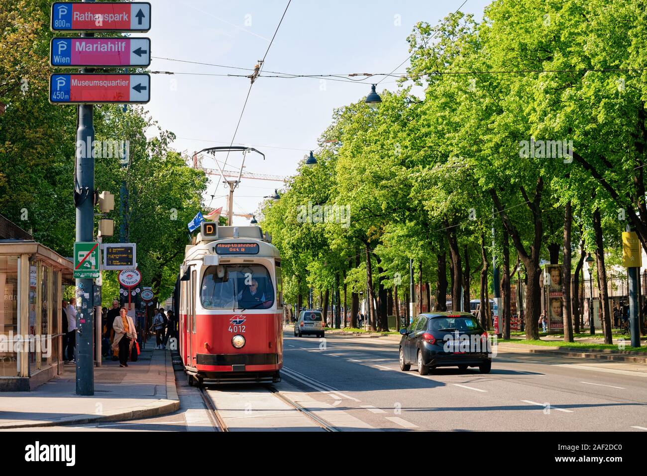 Red tram on road on Museumstrasse in Vienna Stock Photo
