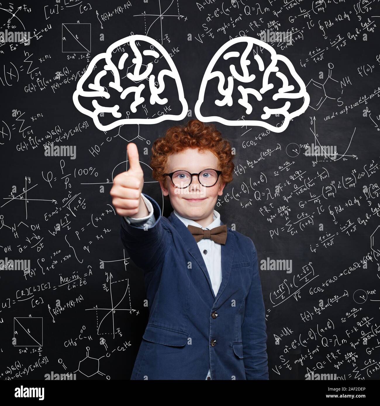Happy child boy smiling and showing thumb up on science background Stock Photo