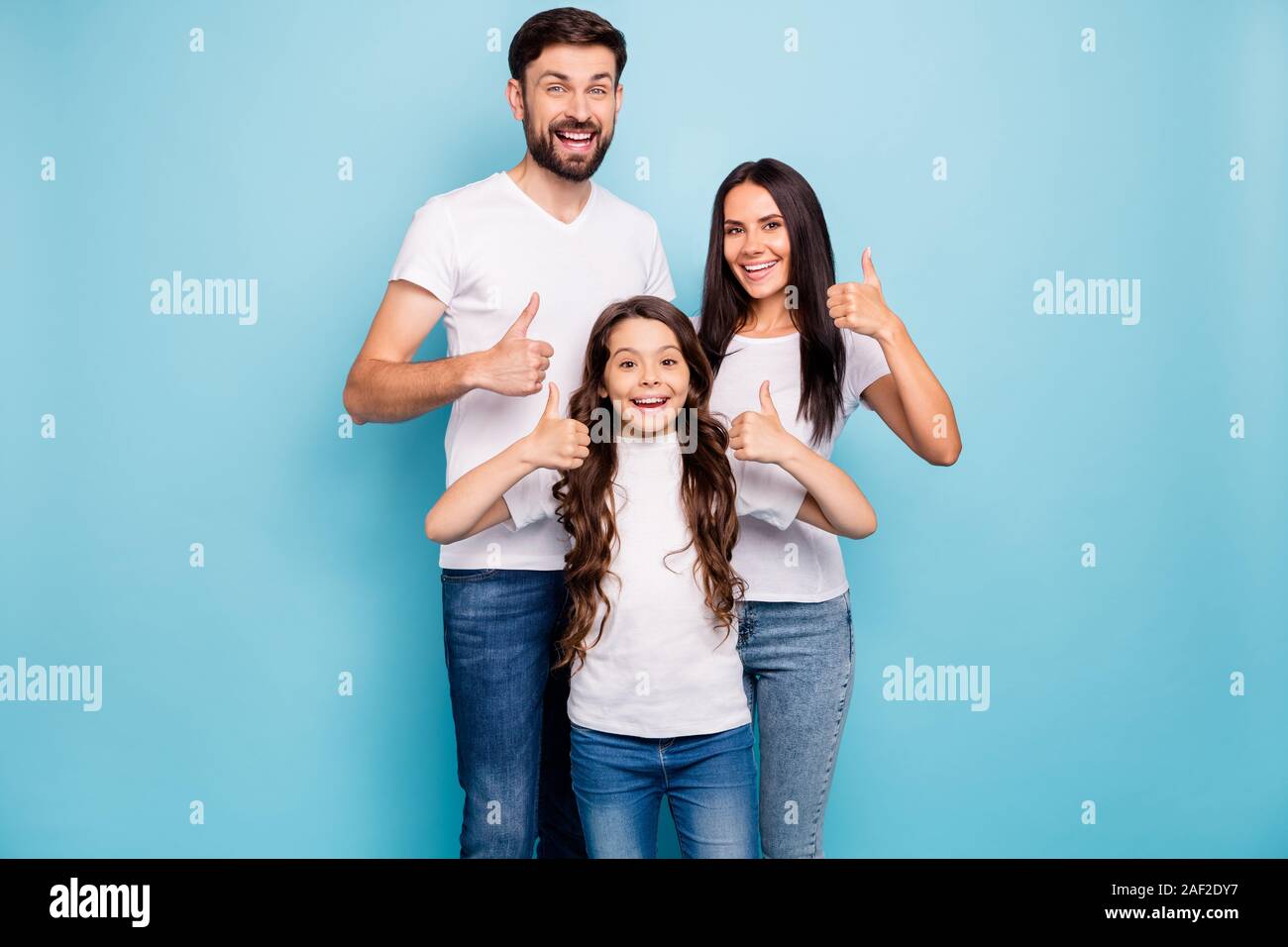 Portrait of cheerful positive three brunet hair people promoters show thumb up recommend sales wear white t-shirt denim jeans casual outfit isolated Stock Photo