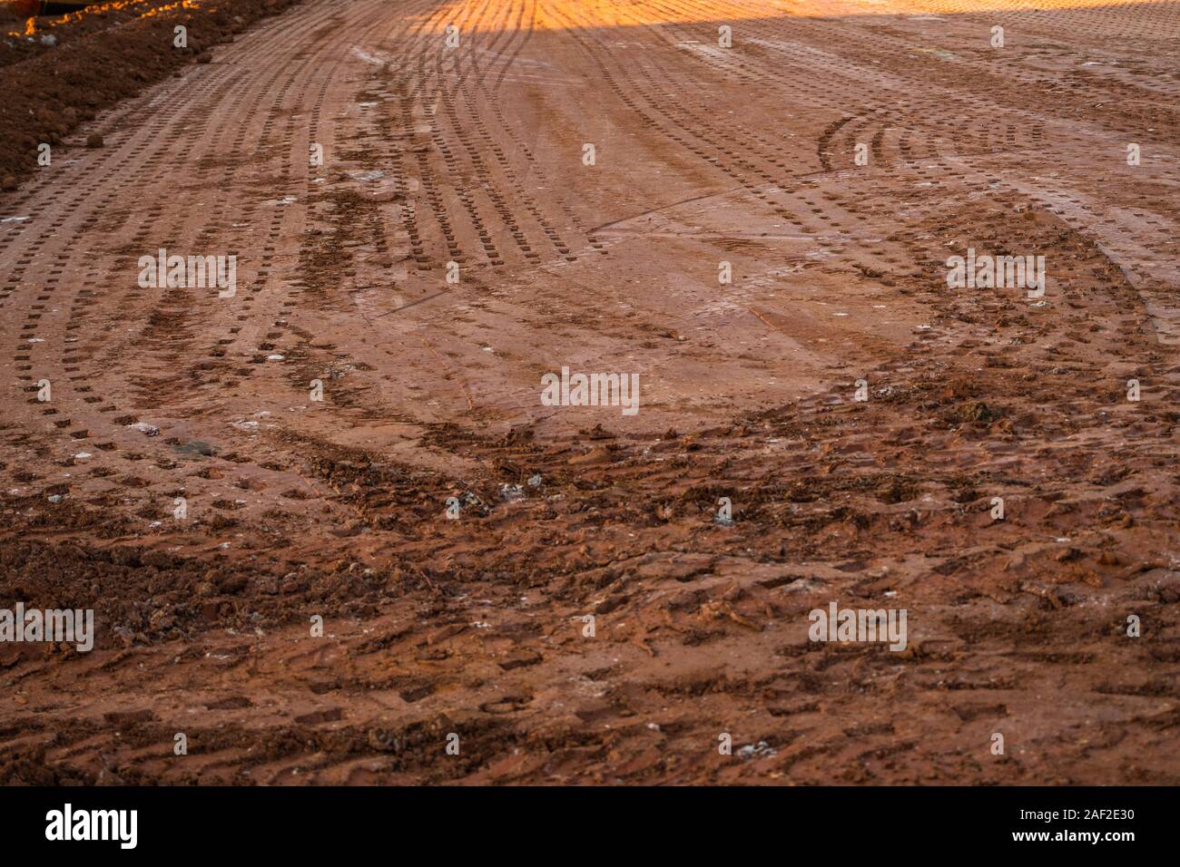 Ground after soil compactor. Paving. Compaction of the road. Stock Photo