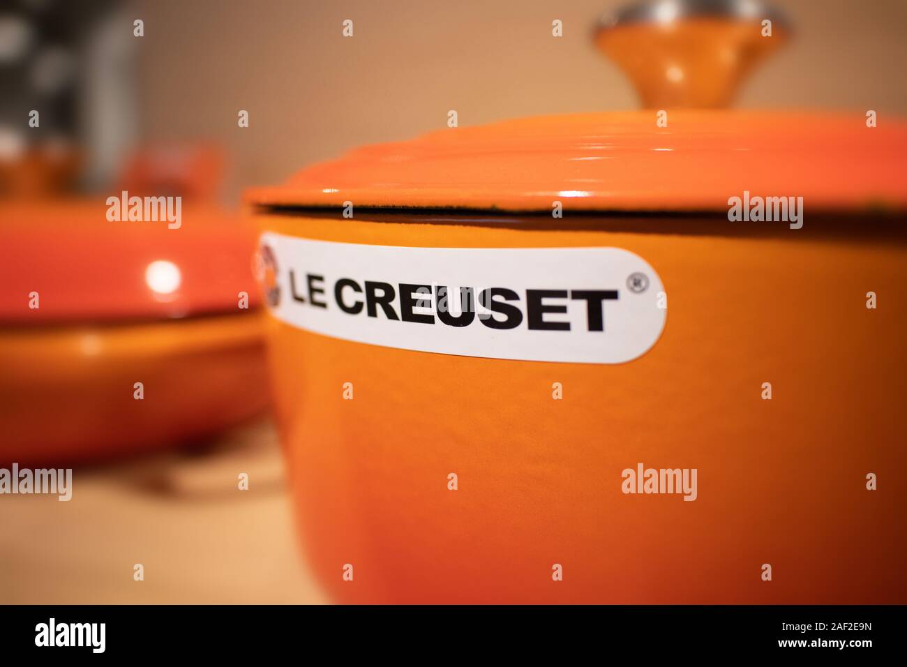 Le Creuset casserole dish in the famous orange colour. It's a premium French  cookware manufacturer known for its colorfully-enameled pots and pans Stock  Photo - Alamy