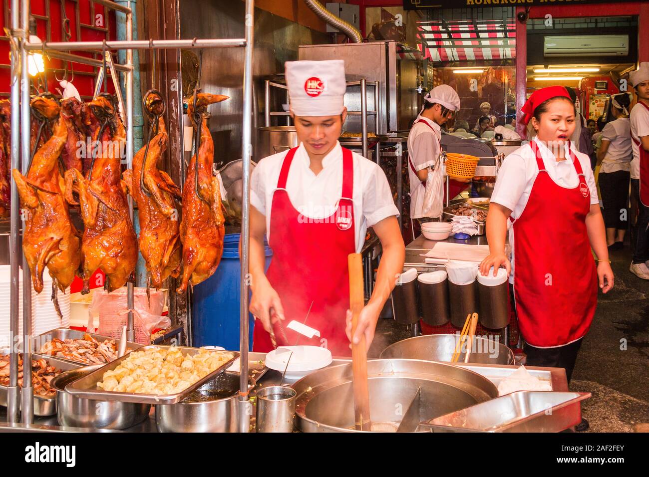 Bangkok, Thailand - October 26th 2013. Kitchen staff in the Hong Noodle restaurant. The establishment is located in Chinatown. Stock Photo