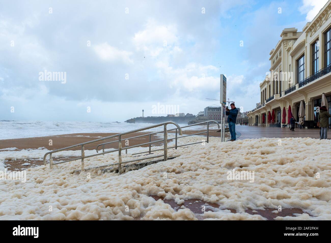 Foam on the Grande Plage beach and its quay in France Stock Photo