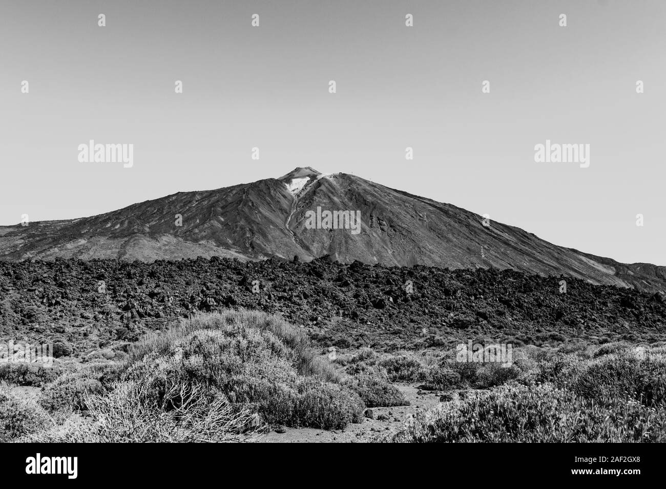 Black And White Shot Of Highest Peak Behind Arid Lava Rocks On A Sunny And Very Clear Day In El Teide National Park. April 13, 2019. Santa Cruz De Ten Stock Photo
