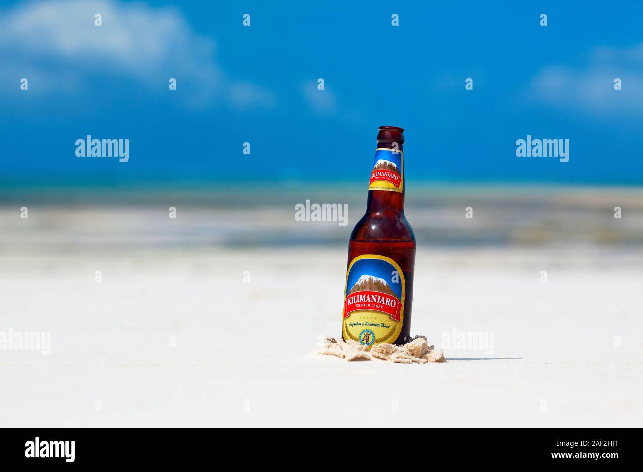 A beer bottle resting on a beach in Zanzibar Stock Photo Alamy