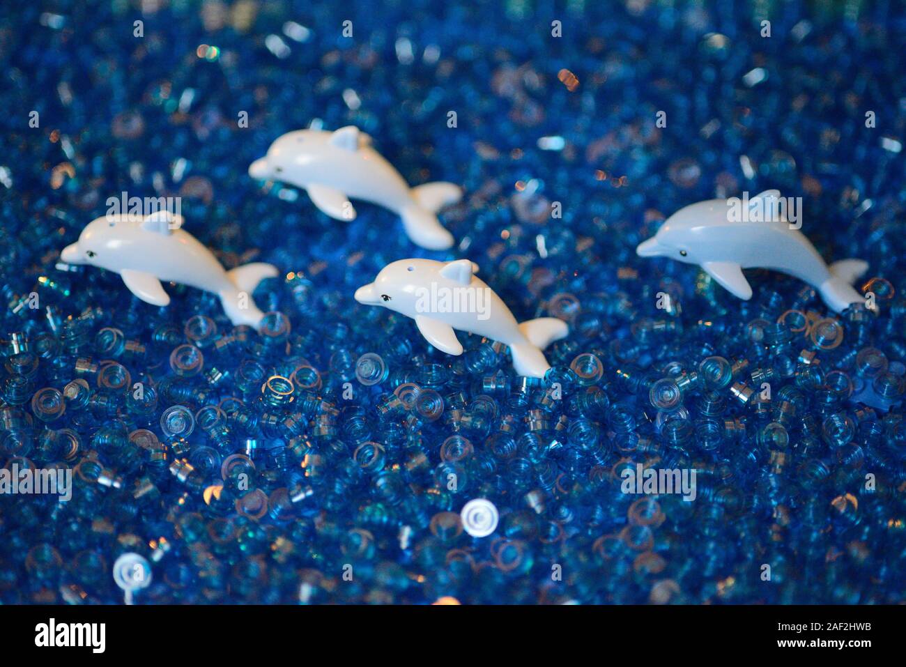 Group of Lego Dolphins Minifigures in the Sea Stock Photo