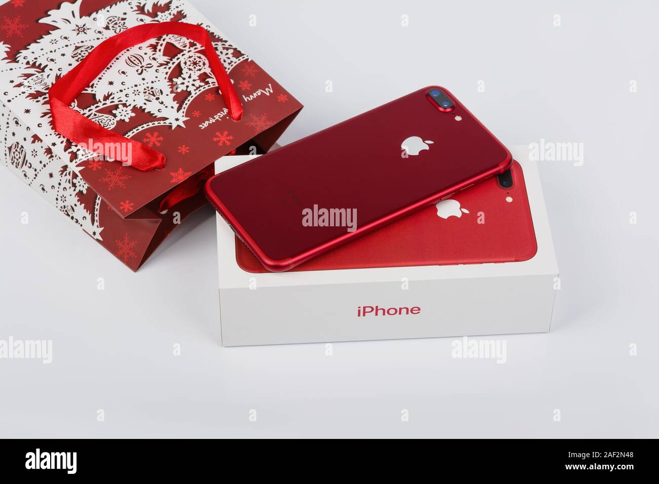 BURGAS, BULGARIA - DECEMBER 10, 2019: Apple iPhone 7 Plus Red Special Edition on white background, back view. Christmas gift. Stock Photo