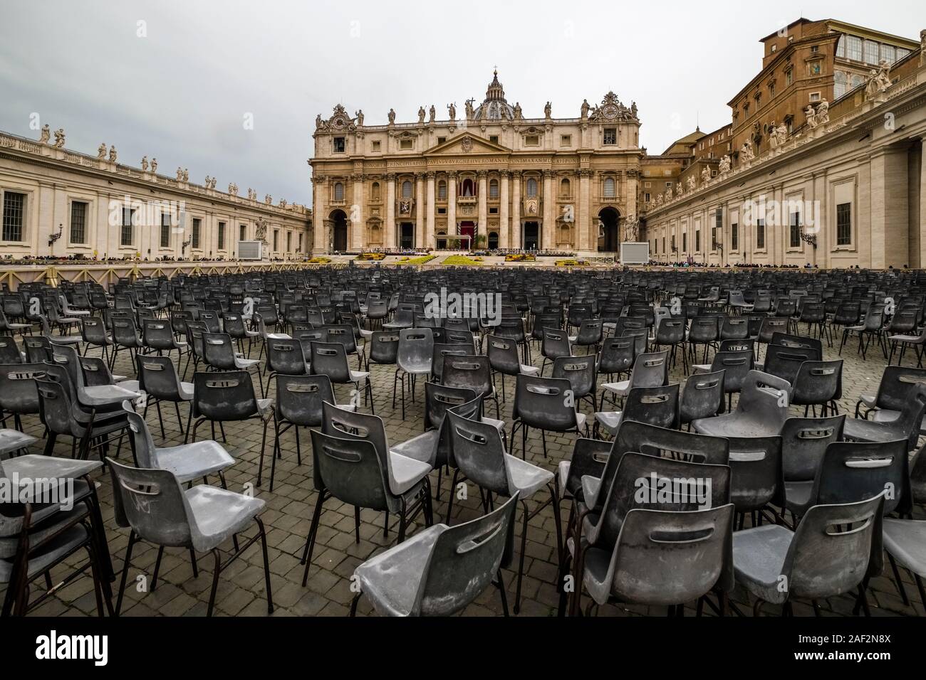 Many empty chairs remain on St. Peter's Square after the Easter sermon of the Pope, the Papal Basilica of St. Peter, St. Peter's Basilica in the dista Stock Photo