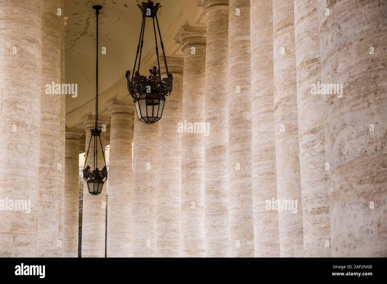 Two antic lamps, attached between the colossal Doric colonnades surrounding the St. Peter's Square Stock Photo
