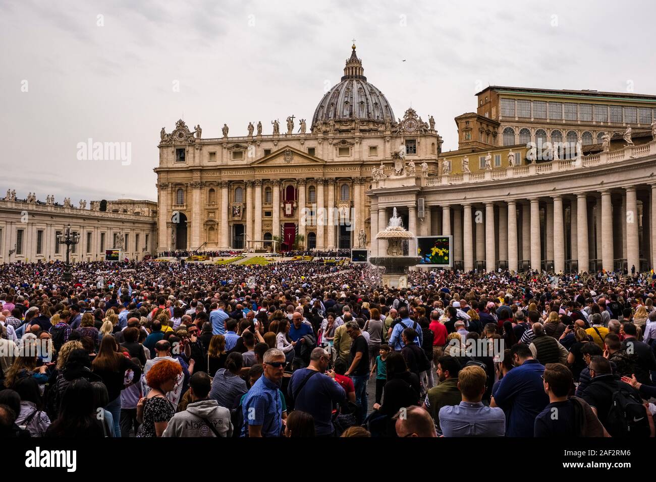 View over St. Peter's Square with thousands of people joining the Easter sermon of the Pope, the Papal Basilica of St. Peter, St. Peter's Basilica in Stock Photo