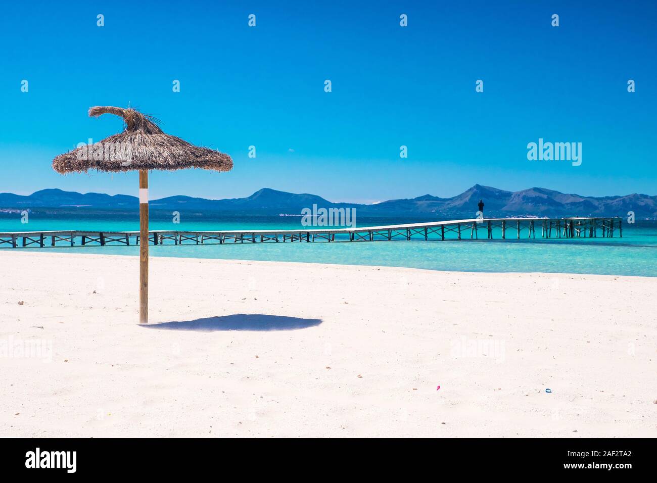 parasol beach on the coast. White sand and blue water of the sea. Playa de Muro, Mallorca, Majorca, Spain Stock Photo