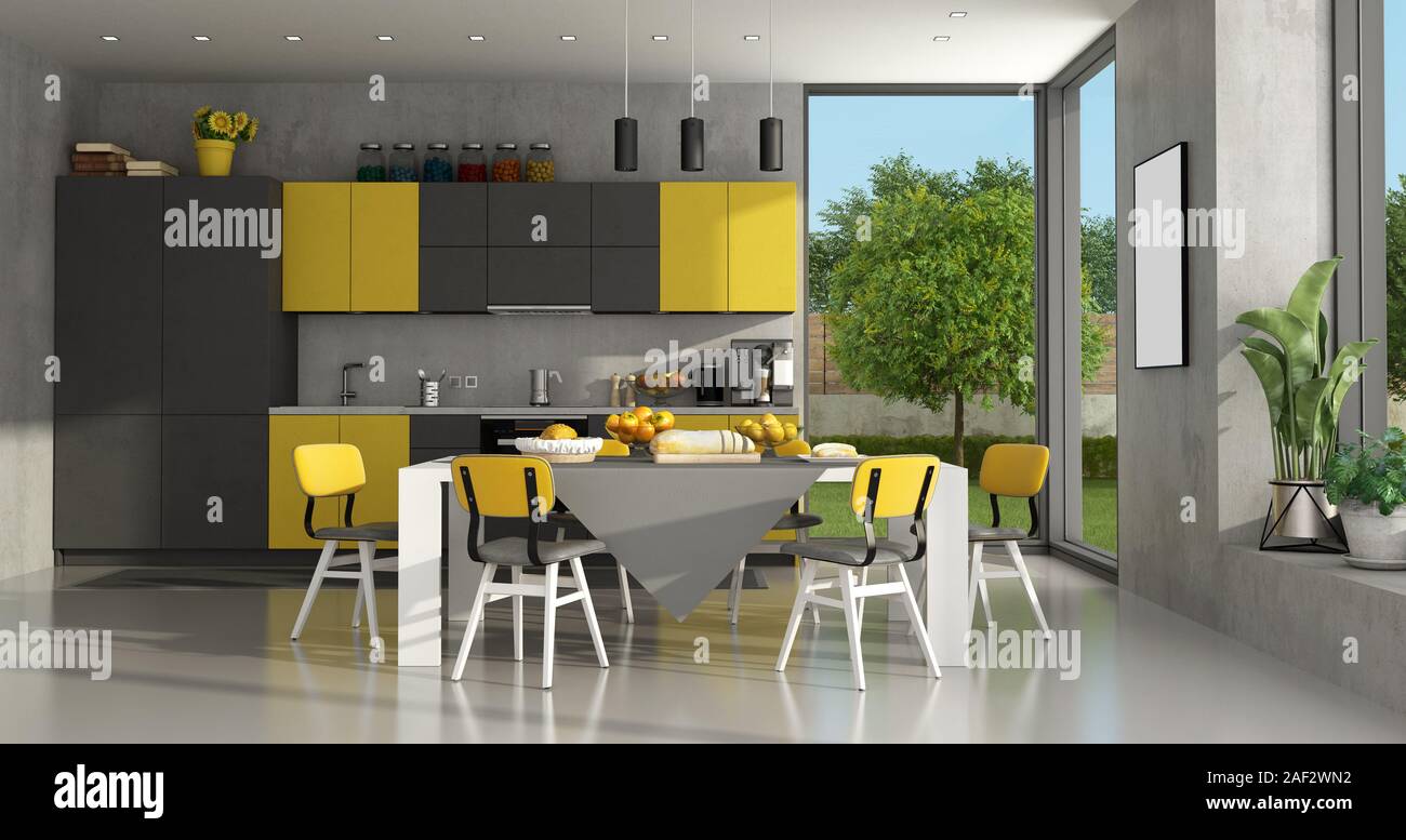 Black and yellow modern kitchen with dining table - 3d rendering Stock Photo