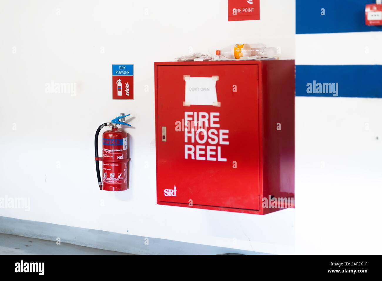 Fire hoses packed inside of red emergency box at the wall Stock Photo