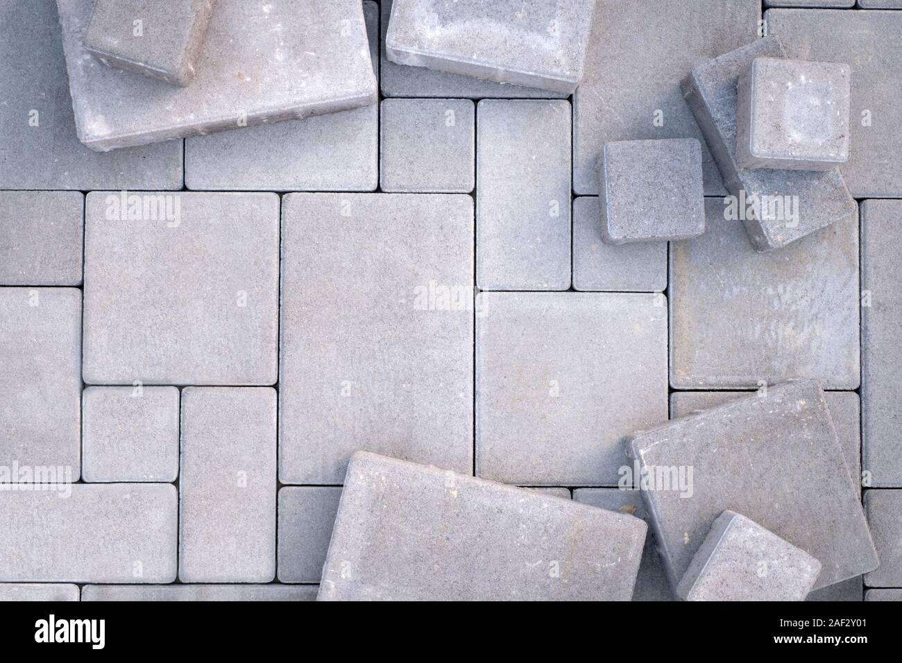 Laying gray concrete paving stones on house courtyard. Pavement background Stock Photo