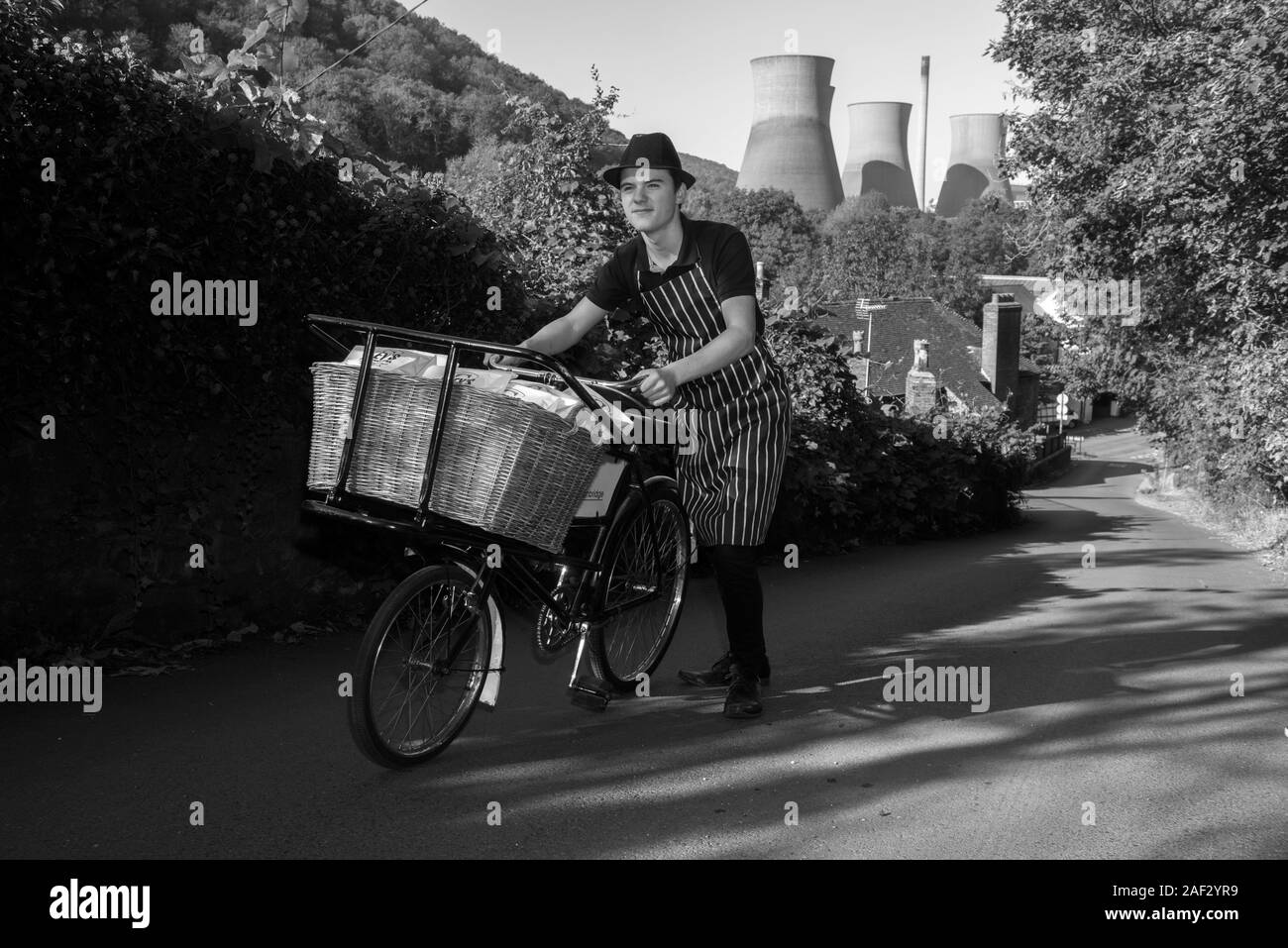 Charlie Eley pushing the family butchers bike up the hills of Ironbridge with the Cooling Towers in the distance. Picture by David Bagnall, Stock Photo