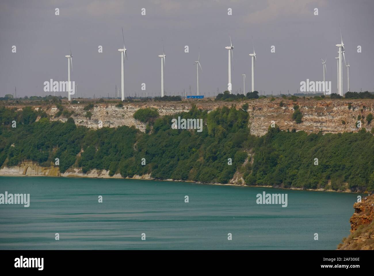 Rocky beach. Wind generators. Green electricity.  Black Sea. Cape Kaliakra, Bulgaria. Stock Photo