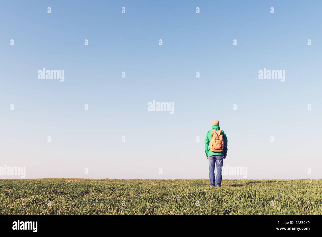 Tourist with backpack alone on summer field. Travel concept Stock Photo