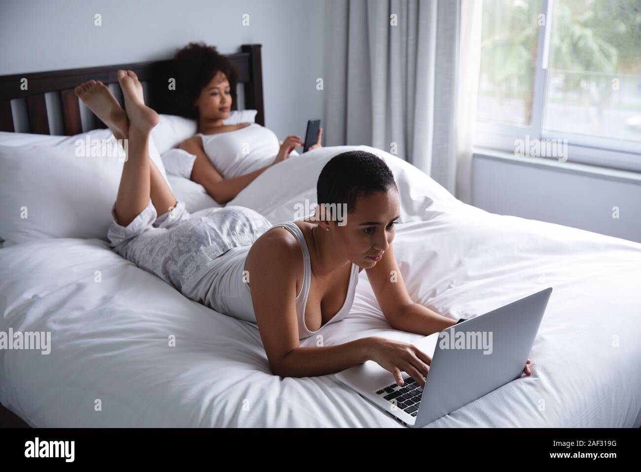 Female couple relaxing at home Stock Photo