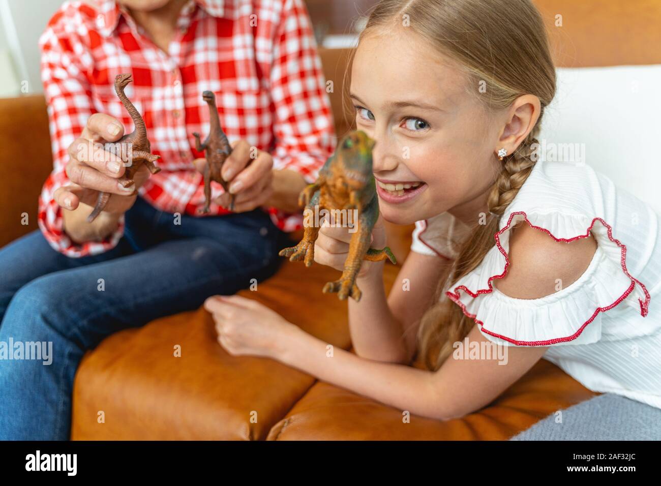Gleeful kid playing with her grandmother indoors Stock Photo