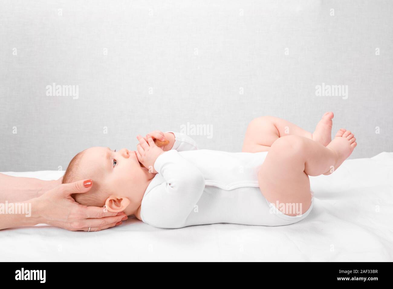 Six month baby girl receiving osteopathic or chiropractic treatment in