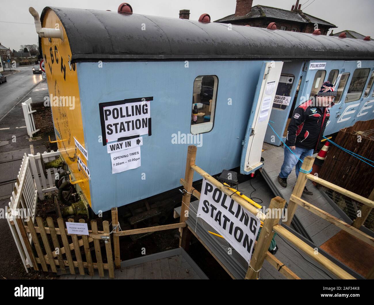 A man leaves a polling station in a railway carriage in Leeming Bar, North Yorkshire, as voters go to the polls in what has been billed as the most important General Election in a generation. Stock Photo