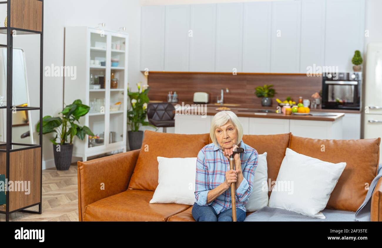 Lonely senior woman with a walking stick Stock Photo - Alamy