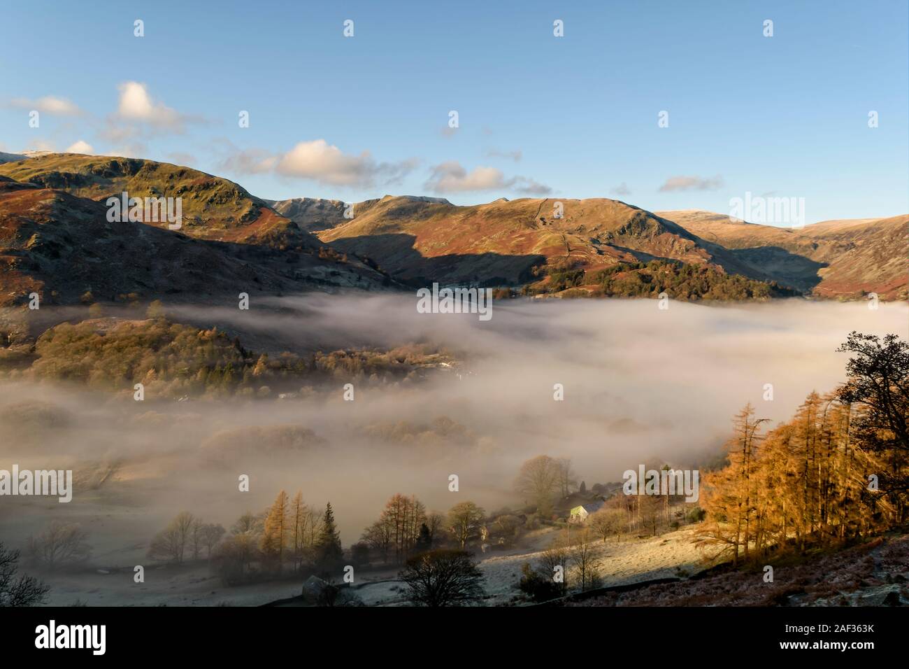 Looking across to Glenridding and the Helvellyn range from the path to Boredale Hause on a frost November morning with a cloud inversion Stock Photo