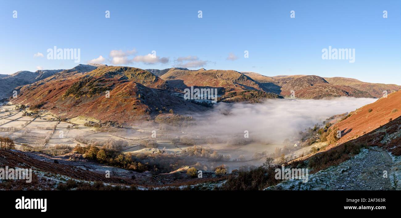 Looking across to Glenridding and the Helvellyn range from the path to Boredale Hause on a frost November morning with a cloud inversion Stock Photo