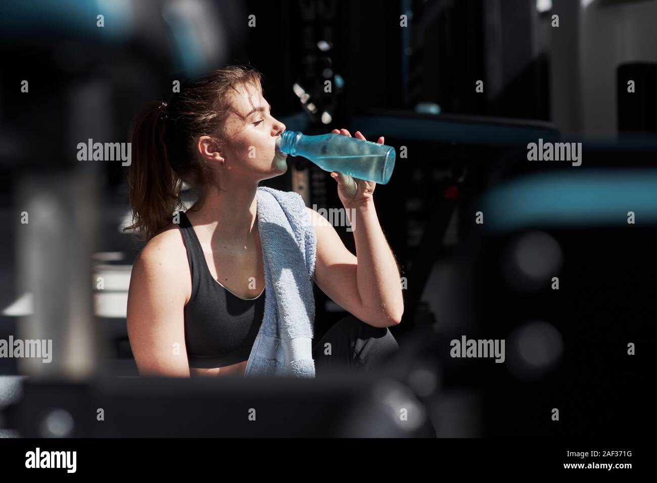 Remember to always bring water with you. Photo of blonde woman in the gym at her