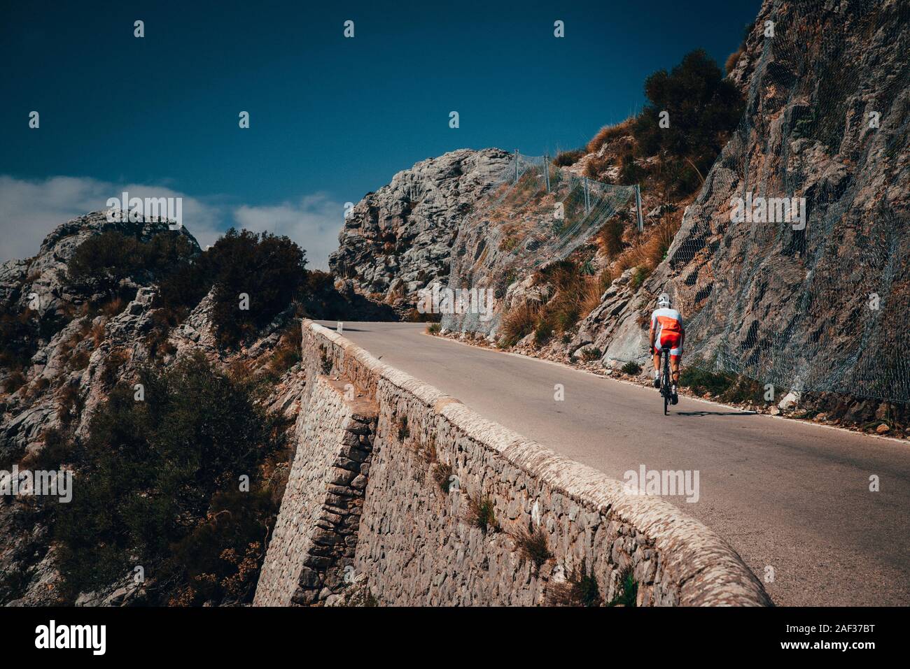 Biker on the road bicycle ride uphill on the famous Sa Calobra climb in Spain. Stock Photo