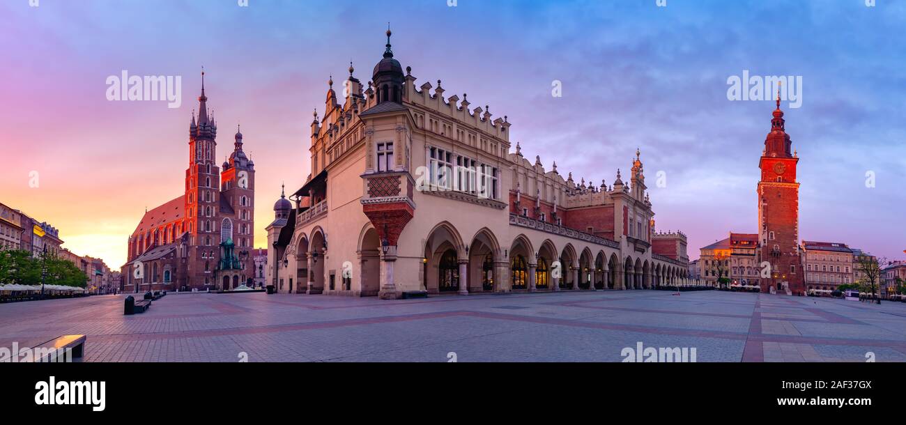 Panorama of Medieval Main market square with Basilica of Saint Mary, Cloth Hall and Town Hall Tower in Old Town of Krakow at sunrise, Poland Stock Photo