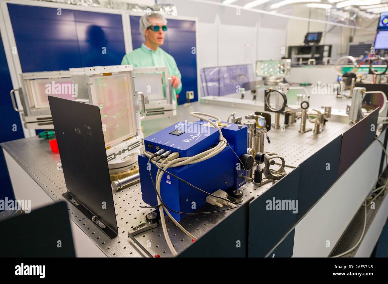 12 December 2019, Bavaria, Unterföhring: Thomas Metzger, technical director  of Trumpf Scientific Lasers, prepares the various stages of the laser for  the lightning protection research project. A European research consortium  wants to