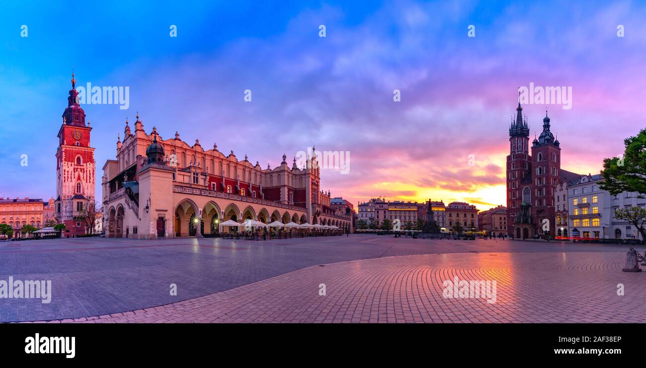 Panorama of Medieval Main market square with Basilica of Saint Mary, Cloth Hall and Town Hall Tower in Old Town of Krakow at sunrise, Poland Stock Photo