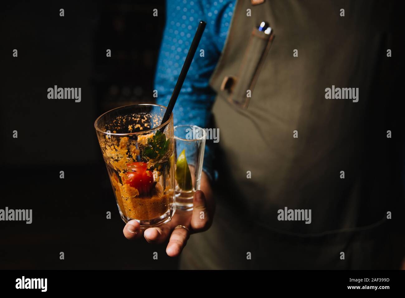 Two dirty glasses in the hands of the waiter. Stock Photo