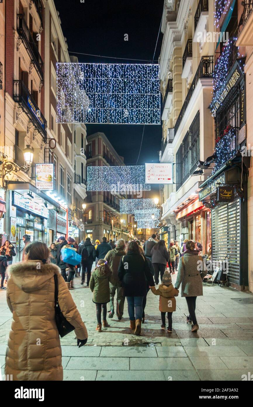 Christmas lights span the street along Calle de Postas in Madrid city centre, Spain Stock Photo