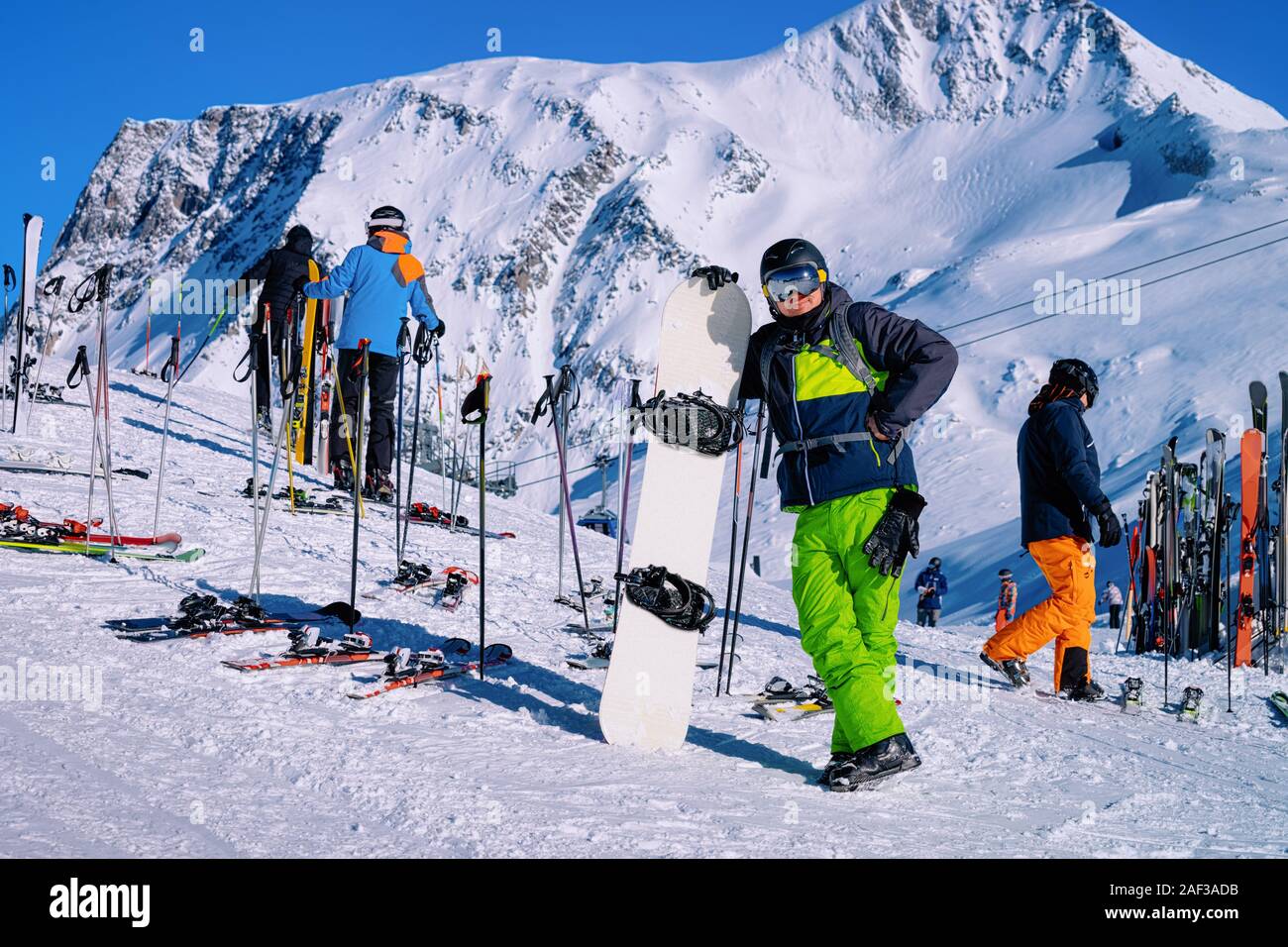 man-with-snowboard-posing-for-photo-in-hintertux-glacier-austria-stock