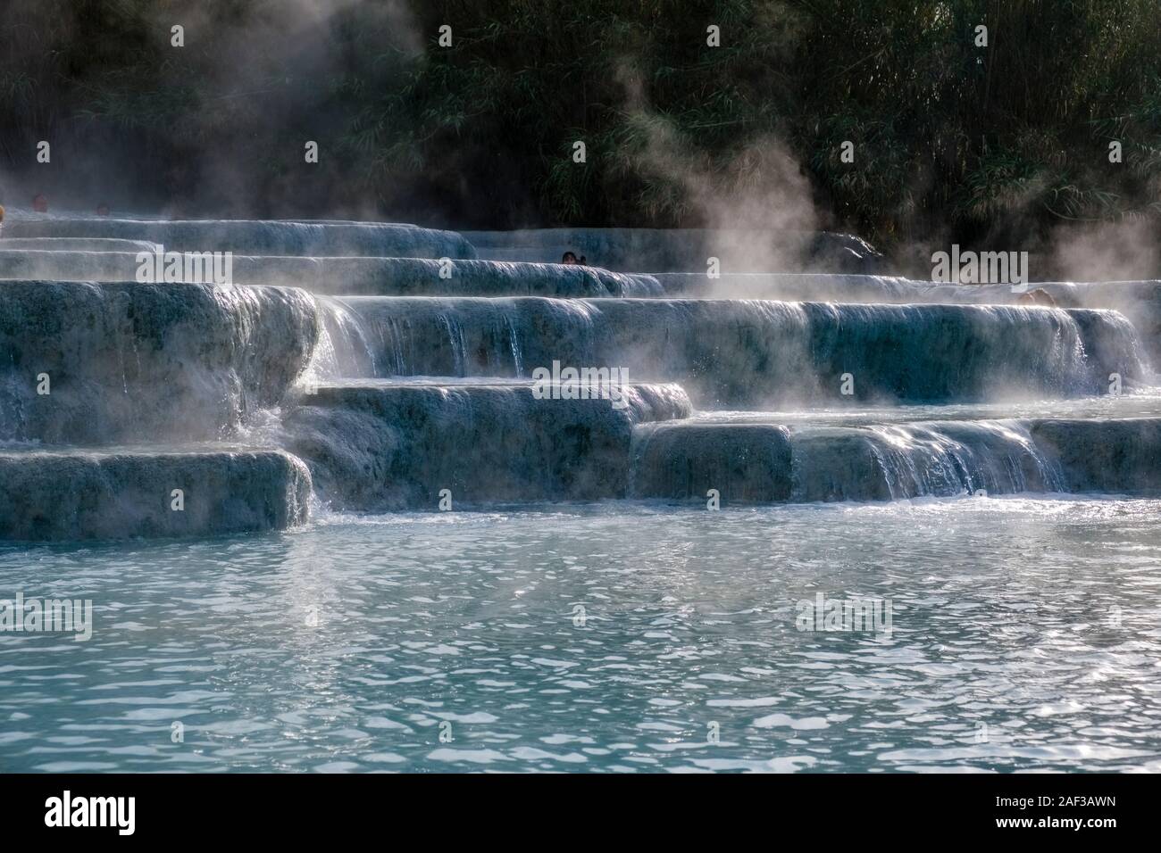 The sulphurous water is flowing over the white cascades of the thermal springs Stock Photo