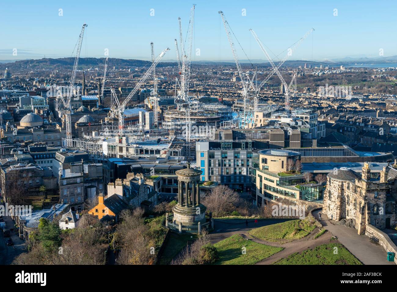 Aerial view of tower cranes at St James Centre redevelopment site with Dugald Stewart Monument in foreground from Calton Hill, Edinburgh, Scotland, UK Stock Photo