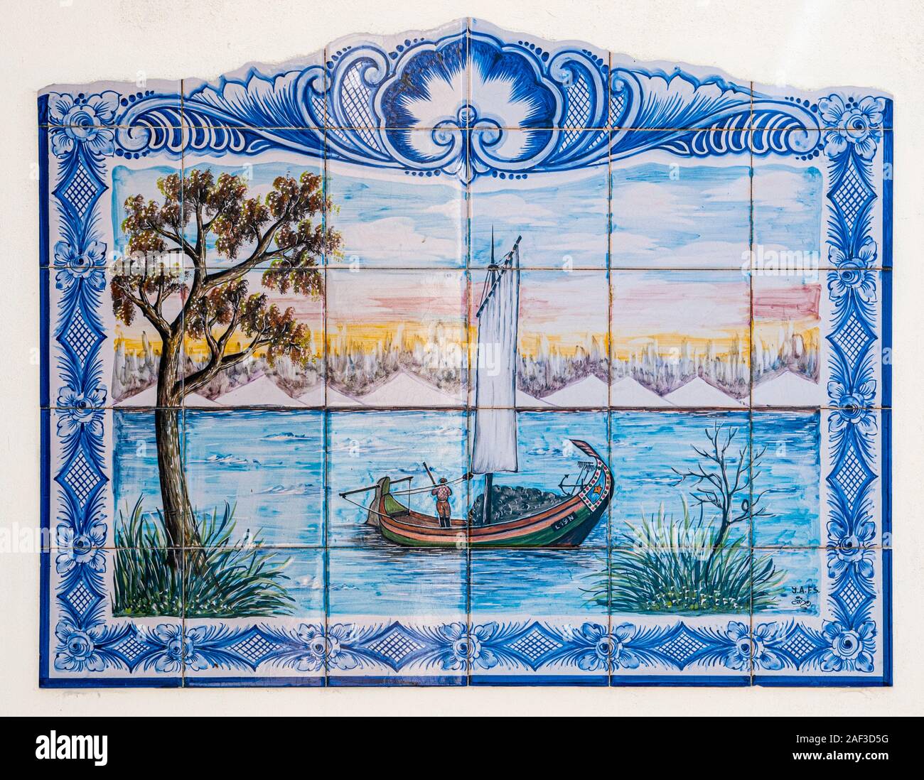 Traditional Portuguese painted tiles (Azulejos) depicting a sail boat harvesting seaweed in the Aveiro Lagoon, Portugal Stock Photo